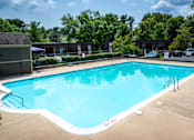 Thumbnail 25 of 29 - A large swimming pool with a white border and a ladder on the side.