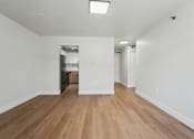 Thumbnail 10 of 41 - A room with wooden floors and white walls.