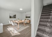 Thumbnail 2 of 41 - A dining room with a wooden table and chairs.