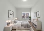 Thumbnail 6 of 41 - A bedroom with a bed, nightstands, and pictures on the wall.