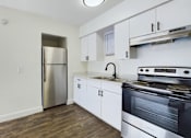 Thumbnail 7 of 23 - A kitchen with a stainless steel refrigerator and oven.