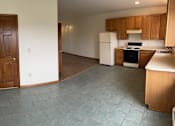 Thumbnail 4 of 53 - A kitchen with a white fridge and wooden cabinets.
