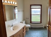 Thumbnail 5 of 53 - A bathroom with a sink, toilet, and window.