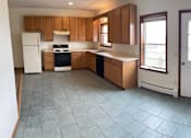 Thumbnail 2 of 53 - A kitchen with wooden cabinets and a white refrigerator.