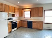 Thumbnail 3 of 53 - A kitchen with wooden cabinets and a white refrigerator.