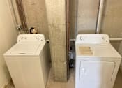 Thumbnail 13 of 53 - A washer and dryer in a small bathroom.