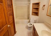 Thumbnail 11 of 53 - A bathroom with a toilet, sink, and shower.