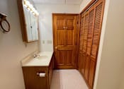Thumbnail 29 of 53 - A bathroom with a toilet, sink, and medicine cabinet.