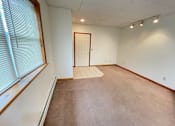 Thumbnail 17 of 53 - A room with a brown carpet and a white door.