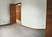 Thumbnail 28 of 53 - A room with a wooden door and a window.