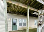 Thumbnail 41 of 53 - A wooden deck with a green door and windows.