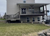 Thumbnail 40 of 53 - A house with a grey roof and a balcony.