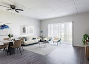 Thumbnail 8 of 25 - A living room with a white couch, a dining table with chairs, and a television on a wooden stand.