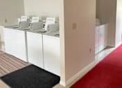 Thumbnail 38 of 49 - A row of white chairs are lined up against a wall.