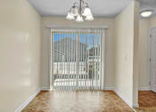 Thumbnail 16 of 55 - A room with a sliding door leading to a balcony.