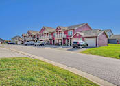 Thumbnail 53 of 55 - A row of houses with cars parked in front.
