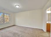 Thumbnail 26 of 55 - A room with a carpeted floor and a window.