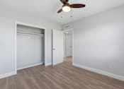 Thumbnail 7 of 18 - A room with a ceiling fan and light fixture.
