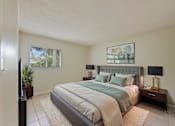 Thumbnail 12 of 14 - A bedroom with a large bed and a flat screen TV.
