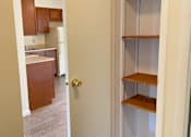 Thumbnail 13 of 49 - A kitchen with a white door and a white wall.