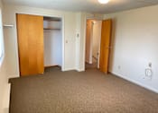 Thumbnail 24 of 49 - A room with carpeted floor and two open doors.