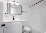 Thumbnail 6 of 12 - a bathroom with a sink toilet and a mirror