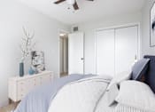 Thumbnail 3 of 12 - a white bedroom with a bed and a ceiling fan