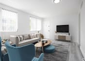 Thumbnail 4 of 12 - a living room with a couch and a table