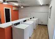 Thumbnail 26 of 26 - a row of white washing machines in a room