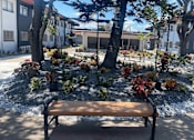 Thumbnail 23 of 26 - a bench in front of a courtyard with trees and plants