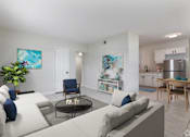 Thumbnail 2 of 16 - a living room with a couch and a table