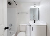 Thumbnail 13 of 16 - a bathroom with a sink toilet and a mirror