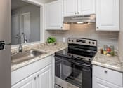 Thumbnail 1 of 21 - a kitchen with a stove and a sink