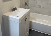 Thumbnail 4 of 21 - a bathroom with a sink and a shower and a mirror