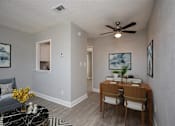 Thumbnail 10 of 21 - a dining room with a table and a ceiling fan