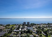 Thumbnail 17 of 18 - an aerial view of a city with a body of water