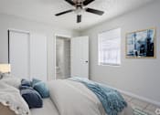Thumbnail 4 of 12 - a bedroom with a large bed and a ceiling fan