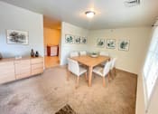 Thumbnail 1 of 30 - A dining room with a wooden table and chairs.