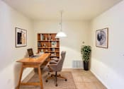 Thumbnail 10 of 30 - A room with a desk, chair, and bookshelf.