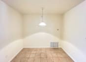 Thumbnail 9 of 30 - A room with a tiled floor and a hanging light fixture.