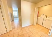 Thumbnail 7 of 30 - A kitchen area with a white fridge and a white door.