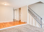 Thumbnail 10 of 17 - A room with a staircase leading to the upper floor.
