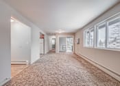 Thumbnail 17 of 38 - A spacious room with a carpeted floor and large windows.