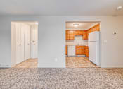 Thumbnail 19 of 38 - A kitchen with white appliances and wooden cabinets.