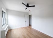Thumbnail 3 of 49 - A room with a ceiling fan and a window with a radiator.