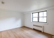 Thumbnail 5 of 49 - A room with a window and a radiator on the wall.