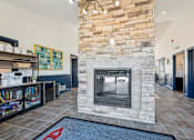 Thumbnail 63 of 65 - A stone fireplace in a room with a blue rug on the floor.