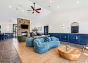 Thumbnail 35 of 65 - A living room with a blue couch and a fireplace.