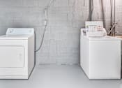 Thumbnail 15 of 17 - Two white appliances in a room with a white wall.