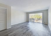 Thumbnail 2 of 23 - A room with a sliding door and a balcony.